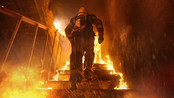 Firefighter running through the fire